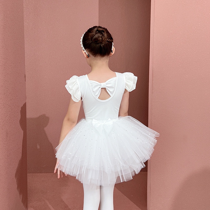 Cute adorable ballerina little girl in pink tutu dance practices